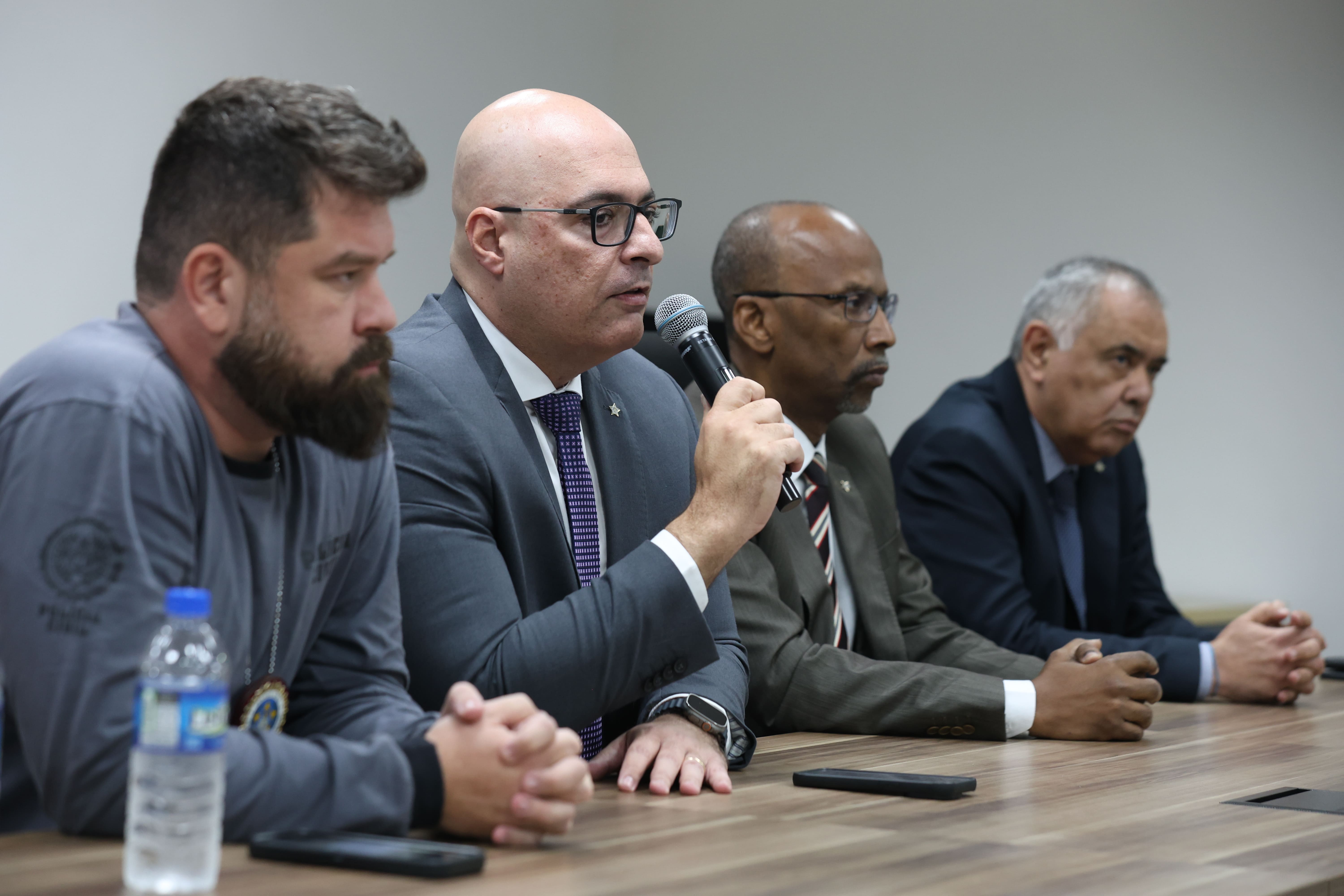 autoridades da policia civil sentadas a mesa durante uma coletiva de imprensa